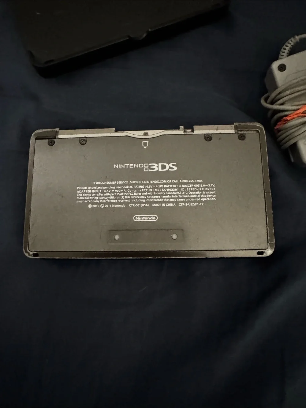 Black Nintendo 3ds with charger and cradle